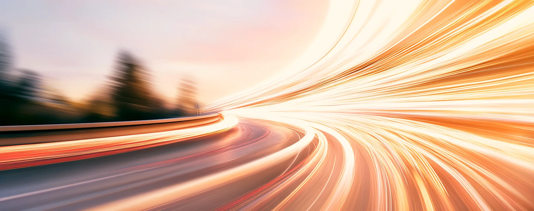Light trails streaking along a curving road at speed